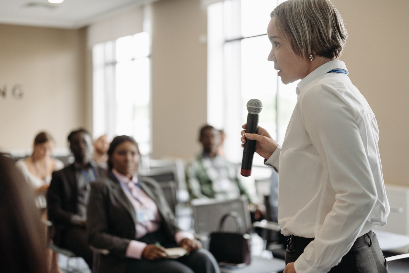 A speaker addresses a training group with a microphone